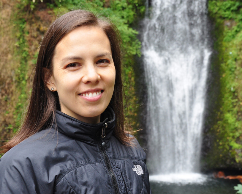 Woman standing in front a waterfall