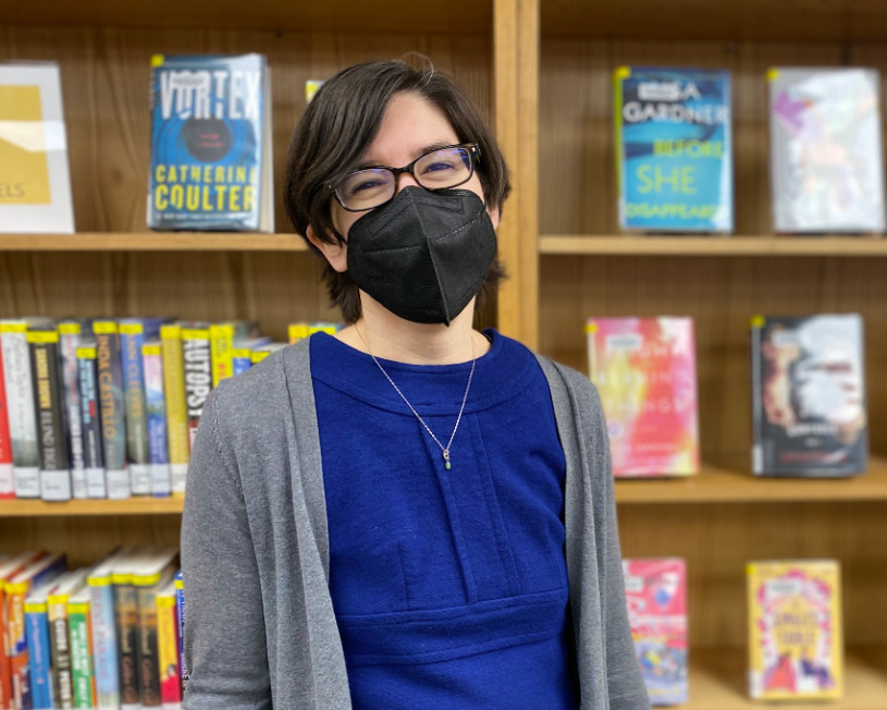 Librarian standing in front of book display 