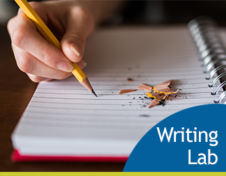 hand writing in notebook with pencil