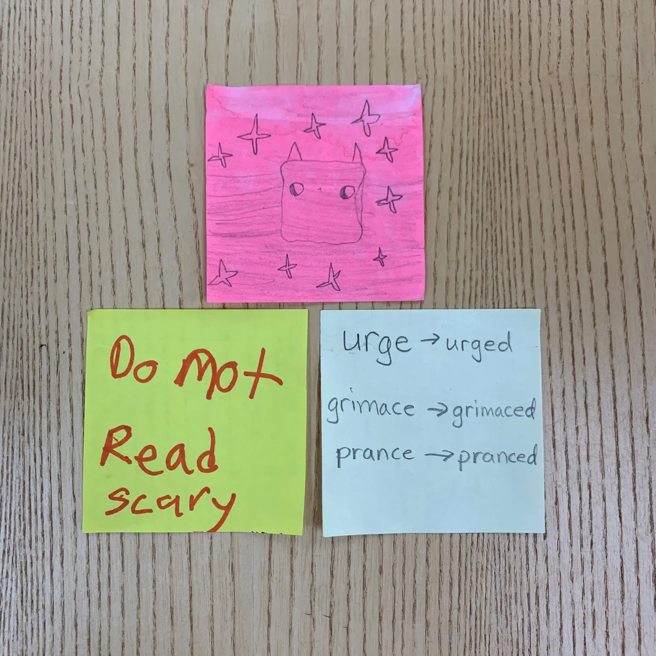 Sticky notes with words and art on them.