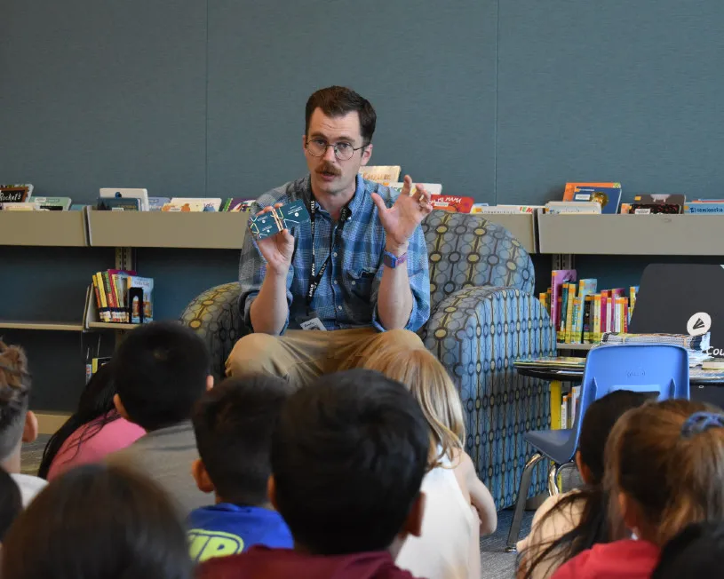 A Cornelius librarian speaking with children.