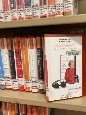 A playaway on a library shelf.