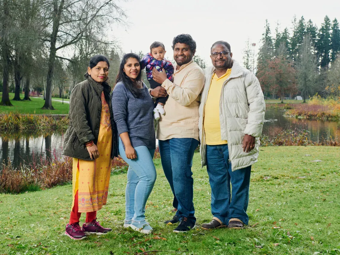 The Gunta family standing in a park.